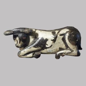 28-18323, Folk art carved wood figure of a recumbent bull, later 19th century. $1,950