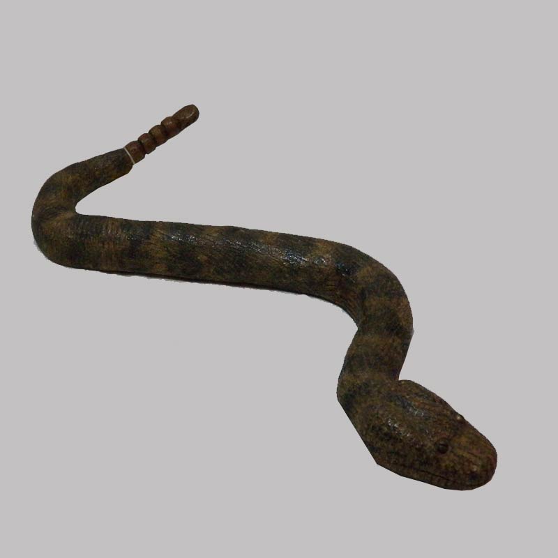 26-15172, Folk art composition of a rattle snake, painted and carved, brass eyes, 18" l. $1,450