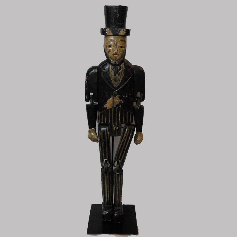 31-23056, Carved and painted wood figure in top hat with moving arms and legs, possibly Lincoln, signed and dated 1942, 25"H. $1,200