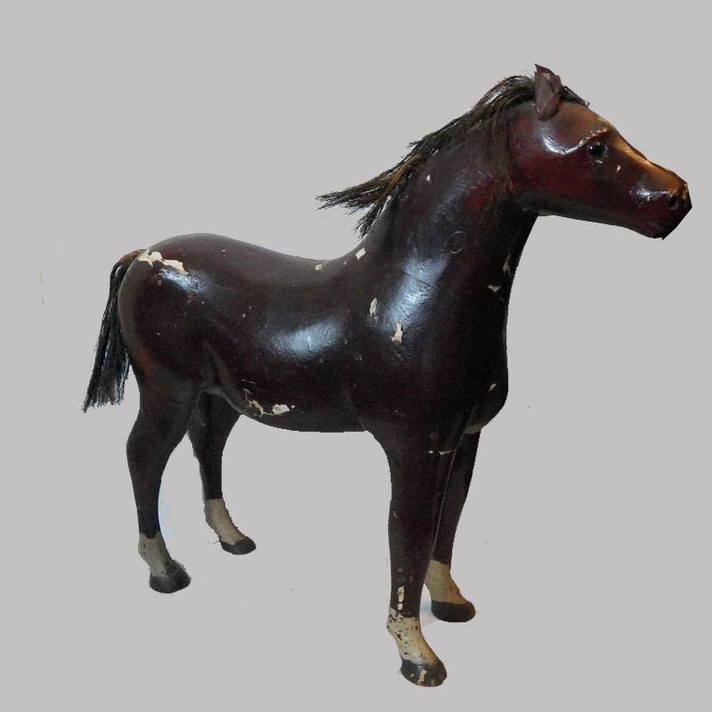 98-119855x, Carved figure of a horse painted with glass eyes, a child's toy, late 19thc, 24"l by 23" H. 2,200