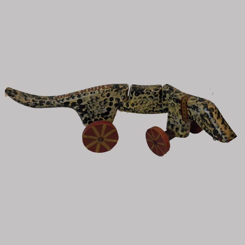 15-25451, Carved and painted wood dog pull toy titled Shimmy Pup missing eye and ear, 1920-30's, 24" L. $495