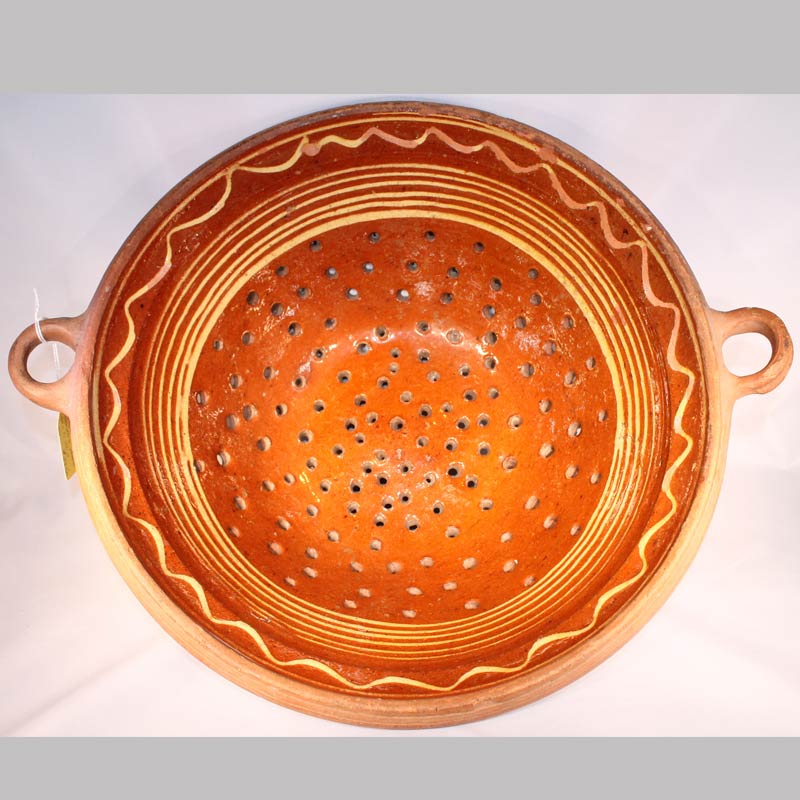 26-13867x, Rare PA Redware pottery colander full yellow slip decorated, applied handles, some loss, 13" Diameter by 5 1/2" H. $3,250