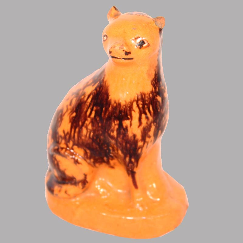 15-25340, PA Redware pottery figural of a seated cat manganese splash and yellow slip eyes, rare form, ear wear, 4"H. $1,950